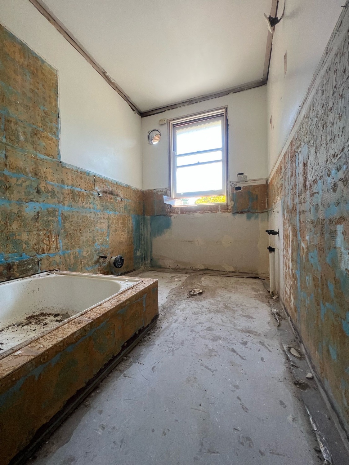 Bathroom stripped back to bare walls on a Sydney site